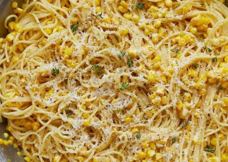 sweet corn cacio e pepe with a light sprinkle of parmesan cheese and thyme