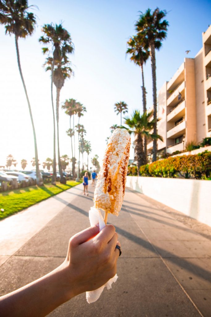 Elotes is Mexican street corn coated in spices, mayonnaise, and cotija cheese